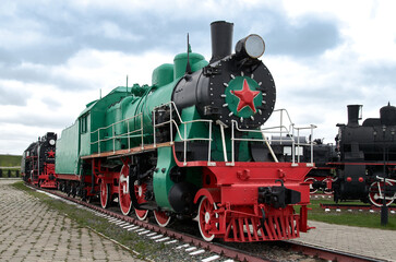 Restored vintage green steam locomotive parked in a museum