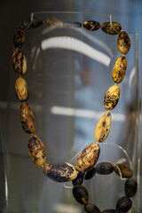 Amber  beads on the glass shelf