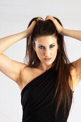 Obraz premium Beautiful woman with her hands in her hair