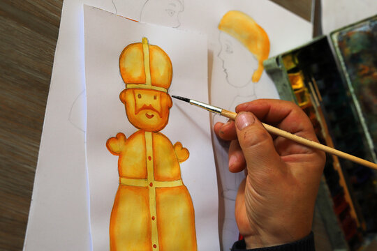 For Saint Nicholas, the animator draws characters from cartoons, comics or puppet shows. Preparation for making a doll. The designer creates sketches. Comics, cartoons, puppet theater
