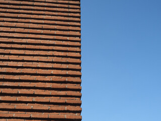 red brick wall over blue sky background