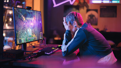 Gaming at Home: Gamer Frustrated by Losing a Round of Playing Online Video Game on Personal Computer. Saddened Female Playing RPG Strategy Arcade Online Multiplayer PvP Tournament. Evening at Home. © Gorodenkoff