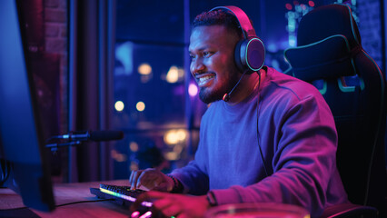 Gaming From Home: Portrait of African American Gamer Wearing Headphones and Playing Online Video...