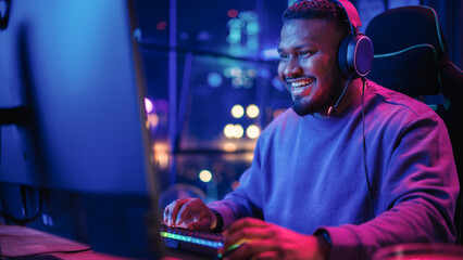 Gaming at Home: Portrait of a Gamer Wearing Headphones and Playing Competitive Video Game on...