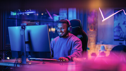 Gaming From Home: Portrait of a Gamer Wearing Headphones and Playing Competitive Video Game on...