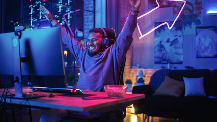Gaming at Home: Black Gamer Playing Online Video Game on Personal Computer. Stylish African American Male Player Enjoying Online Tournament in His Loft Apartment. © Gorodenkoff