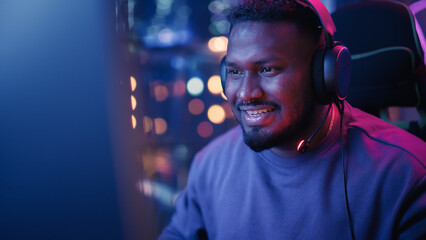 Professional Black Gamer Playing Online Video Game on Computer. Close Up Portrait of Young Man in...