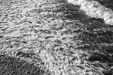 Waves and Sea Foam on the Sand in Waikiki, Hawaii.