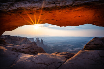 Sunrise at Mesa Arch in Canyonlands National Park Moab Utah with the sun peaking under the arch
