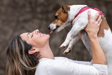 Woman holding Jack Russell dog 