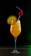 A tropical orange cocktail in a glass is on the table.