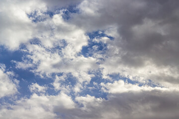 Beautiful blue sky background with cumulus clouds. Sunlight.