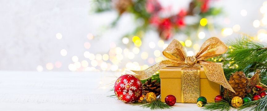 Christmas still life with Christmas gift boxes, festive decorations and fir branches. Banner