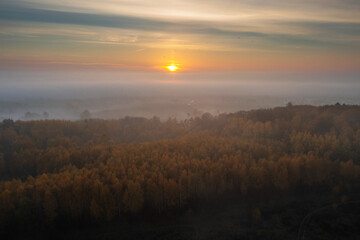 Naklejka na ściany i meble Beautiful landscape with morning fog over the forest in Poland