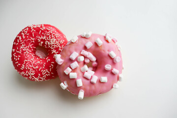 sweet dessert. round donuts with pink icing isolated on white background