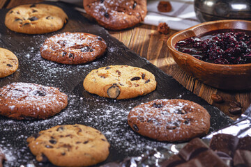 Cookies with chocolate and coffee on a wooden table, selective focus, close up