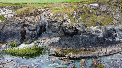 Large stones on the seashore. The rocky coastline of southern Ireland. Beautiful nature of northern Europe. Aerial photo.