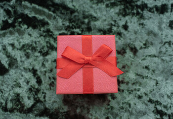 Christmas concept. On a green velvet background, a yellow gift garland and New Year's toys. Postcard for the new year.