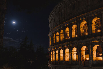 Roman Colosseum at night and the moon 