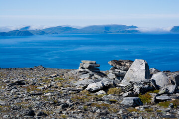 View from northern stony coast of Havoya towards Rolvsoya and Ingoya islands, Norway