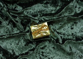 Christmas concept. On a green velvet background, a yellow gift garland and New Year's toys. Postcard for the new year.