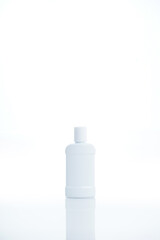 Liquid plastic bottle with transparent cap. Empty mockup bottle isolated on white background with copy space.