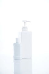 White containers and bottles isolated on white background