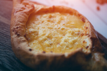 fresh adjarian khachapuri boat woth suluguni cheese, egg yolk and butter