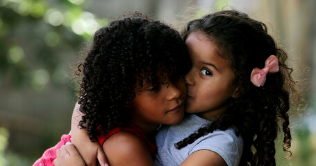 Two Brazilian sisters warm hug and kiss