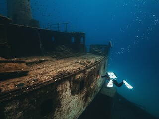 Scuba diver diving on top of wreck, Gozo island, Malta