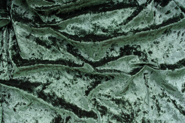 Christmas concept. On a green velvet background, a yellow gift garland and New Year's toys. Postcard for the new year.