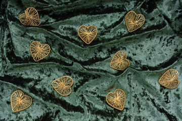 Christmas concept. On a green velvet background, a yellow gift garland and New Year's toys. Postcard for the new year.