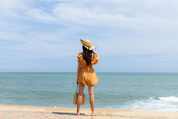 Fototapeta na wymiar Tourist woman stand on the beach