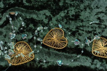 Christmas concept. On a green velvet background, a yellow gift garland and New Year's toys. Postcard for the new year.