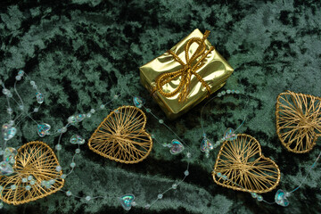 Christmas concept. On a green velvet background, a yellow gift garland and New Year's toys. Postcard for the new year.