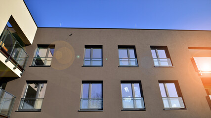 Fototapeta premium New apartment building on a sunny day. Modern residential architecture. The apartment is waiting for new residents.