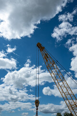 Crane hook. Ropes, slings for lifting cargo. Polyspast construction. Summer. Day.