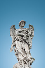 Cover page with statue of a beautiful holy angel with wings at the Saint Angel bridge at blue sky gradient background, Rome, Italy, with copy space.