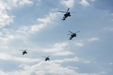 Boeing AH-64 attack helicopters on formation during an air show. Greek Air Force Apache flying on Thessaloniki, Greece during the 28 October National Oxi Day parade.