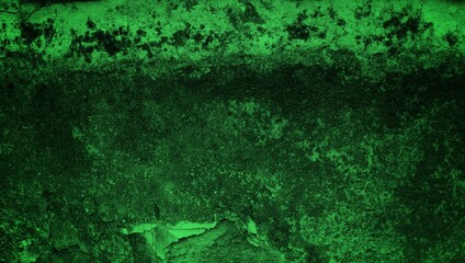 Fototapeta premium A textured green grunge background with dark patches and rough surface