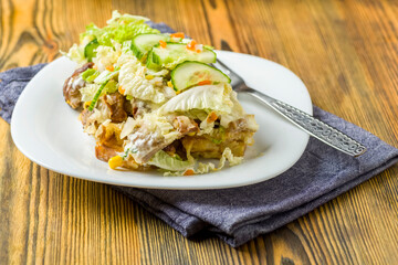 fries baked with meat, cheese and vegetables