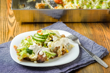 fries baked with meat, cheese and vegetables
