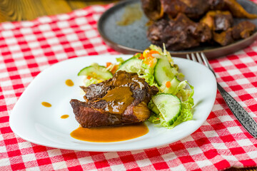 pieces of roasted pork meat and  vegetable salad