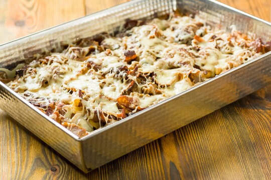 fries baked with meat, cheese and vegetables