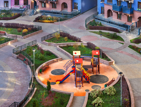 Top view children playground and house building exterior mixed-use urban multi-family residential complex district.