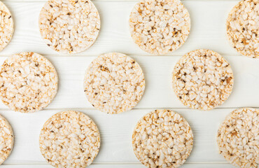 Round rice cakes on a white wooden table. Crispbread.Puffed rice bread. diet crispy round rice cakes.Place for text. Place for copy. Healthy food. dietary product.