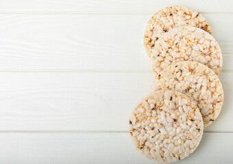 Round rice cakes on a white wooden table. Crispbread.Puffed rice bread. diet crispy round rice cakes.Place for text. Place for copy. Healthy food. dietary product.
