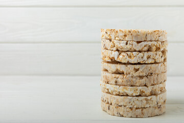 Round rice cakes on a white wooden table. Crispbread.Puffed rice bread. diet crispy round rice cakes.Place for text. Place for copy. Healthy food. dietary product.