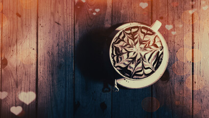 A cup of cappuccino  with a beautiful latte art pattern with heart patterns and bokeh lights for Valentine's Day