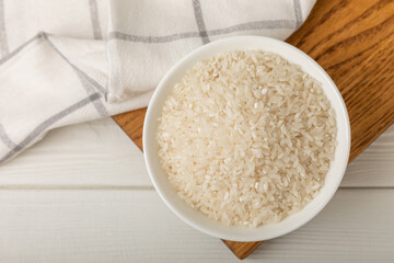 Healthy food. A bowl of steamed rice on a white wooden background. Place for text, copy space. Diet porridge.